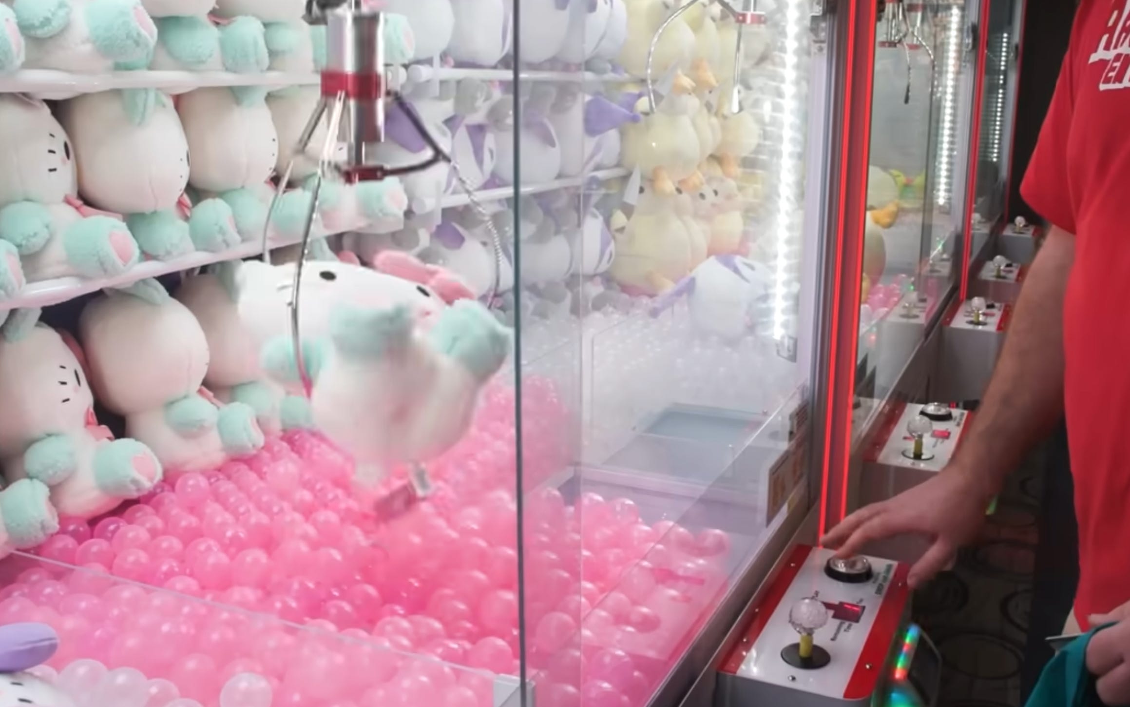 Mike Nay playing a claw machine and losing