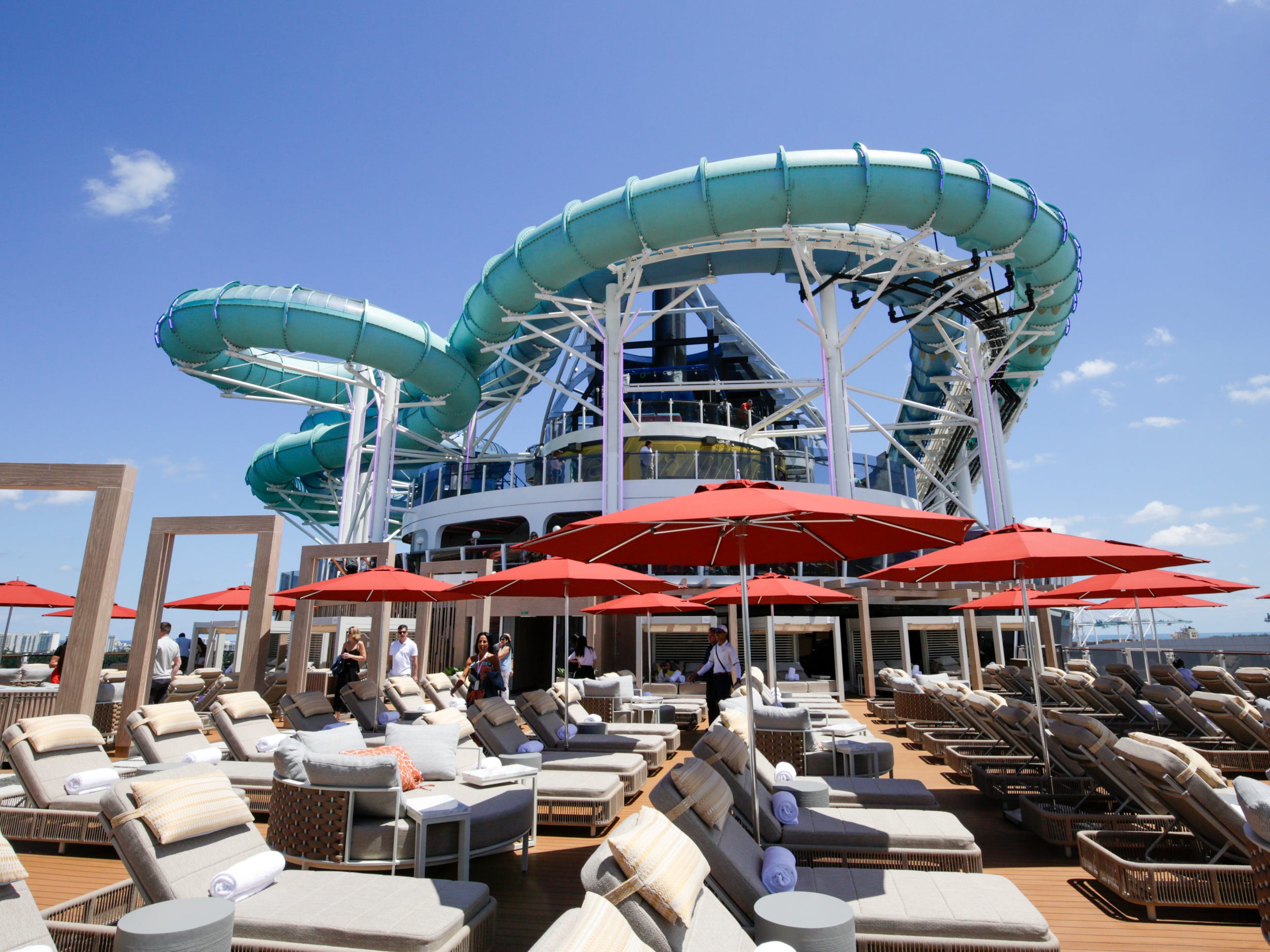 outdoor Vibe Beach Club lounge in front of a waterslide on Norwegian Aqua