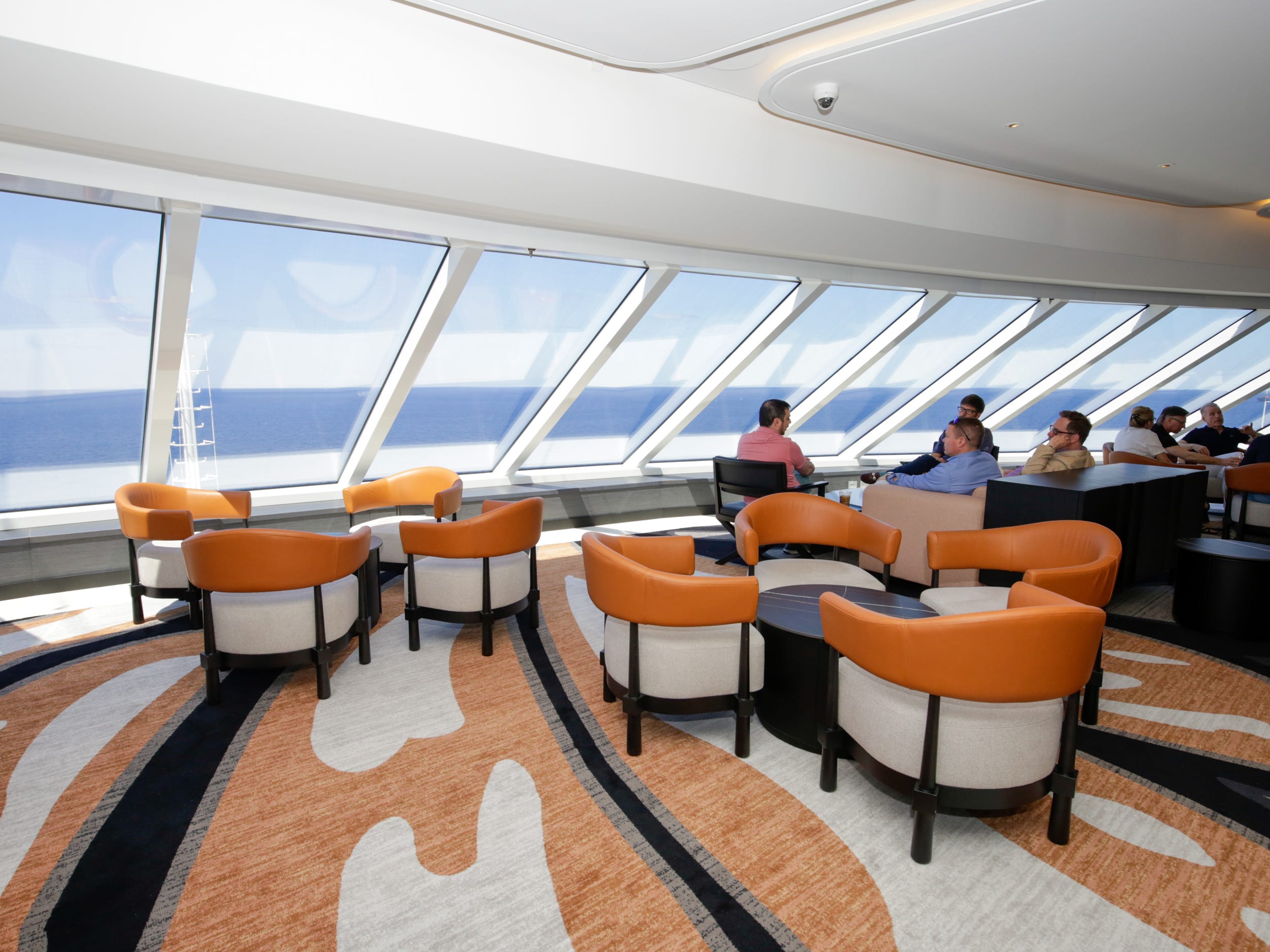 people sitting at chairs at the Observation Lounge on Norwegian Aqua