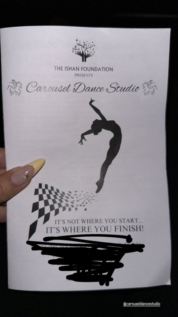 Khloe Kardashian holding a dance recital pamphlet