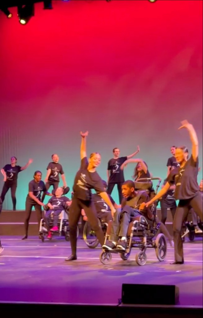 Dancers pushing Amari Thompson's wheelchair