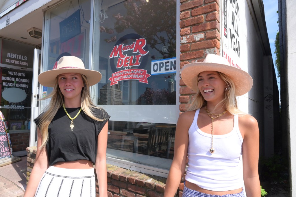 Tourist Kamtyn Spivia (wearing black tank top) and friend Presley Ross (wearing white top) strolling along in Montauk. May 12th, 2025.