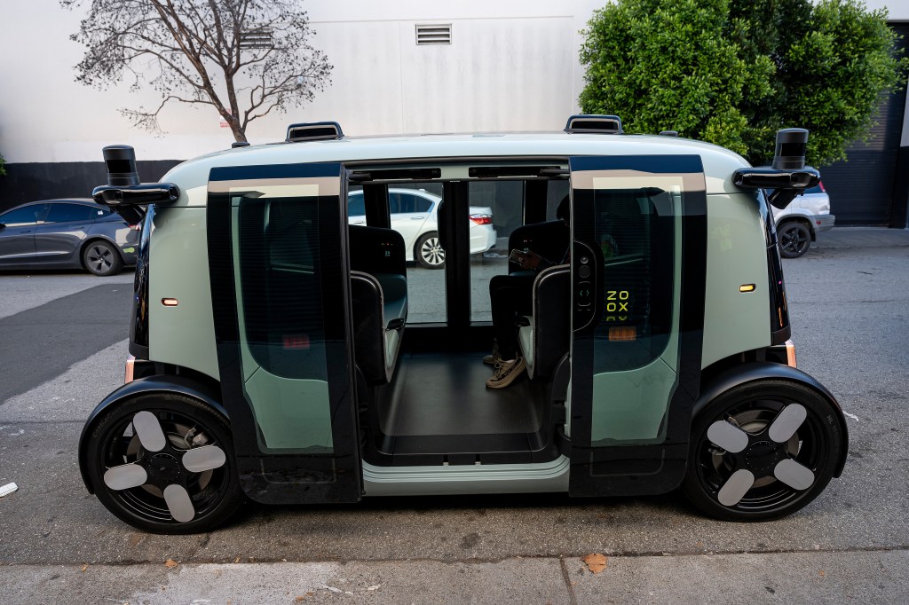 A Zoox autonomous robotaxi on the streets of San Francisco's SoMa neighborhood during testing in December 2024