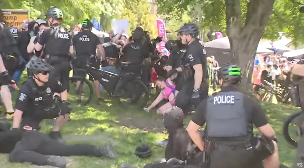 Police arrested 23 people over about five chaotic hours at the protest in Seattle's LGBTQ neighborhood Saturday