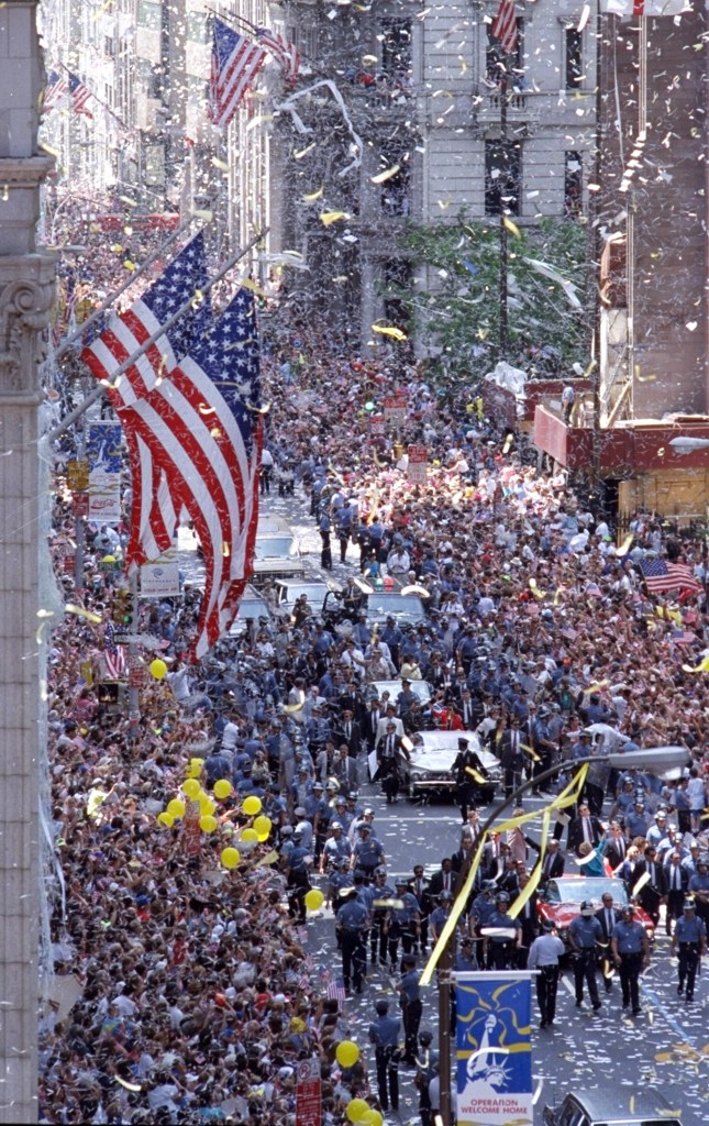 Ticker tape raining down on vehicles carrying Secretary of Defense Dick Cheney, Joint Chiefs Chairman Colin Powell, and Desert Storm Commander Gen. H. Norman Schwarzkopf during the Operation Welcome Home parade, 1991