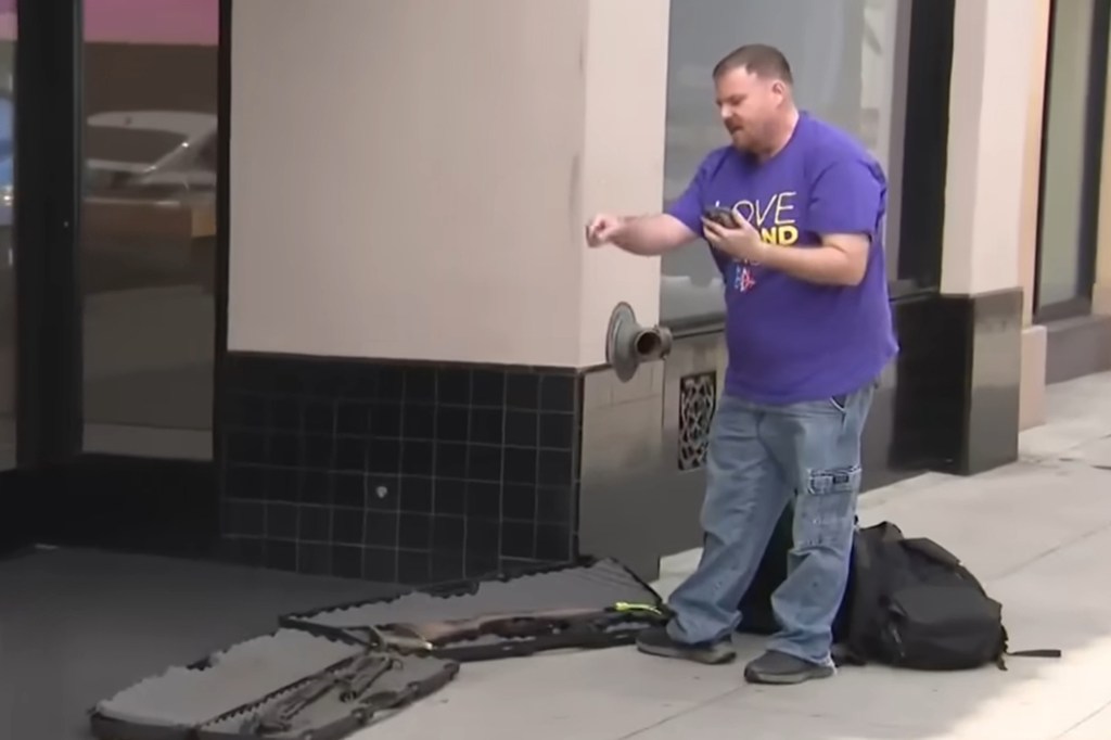 The man opened gun cases on the sidewalk and counted out six weapons in total before police arrived and detained him
