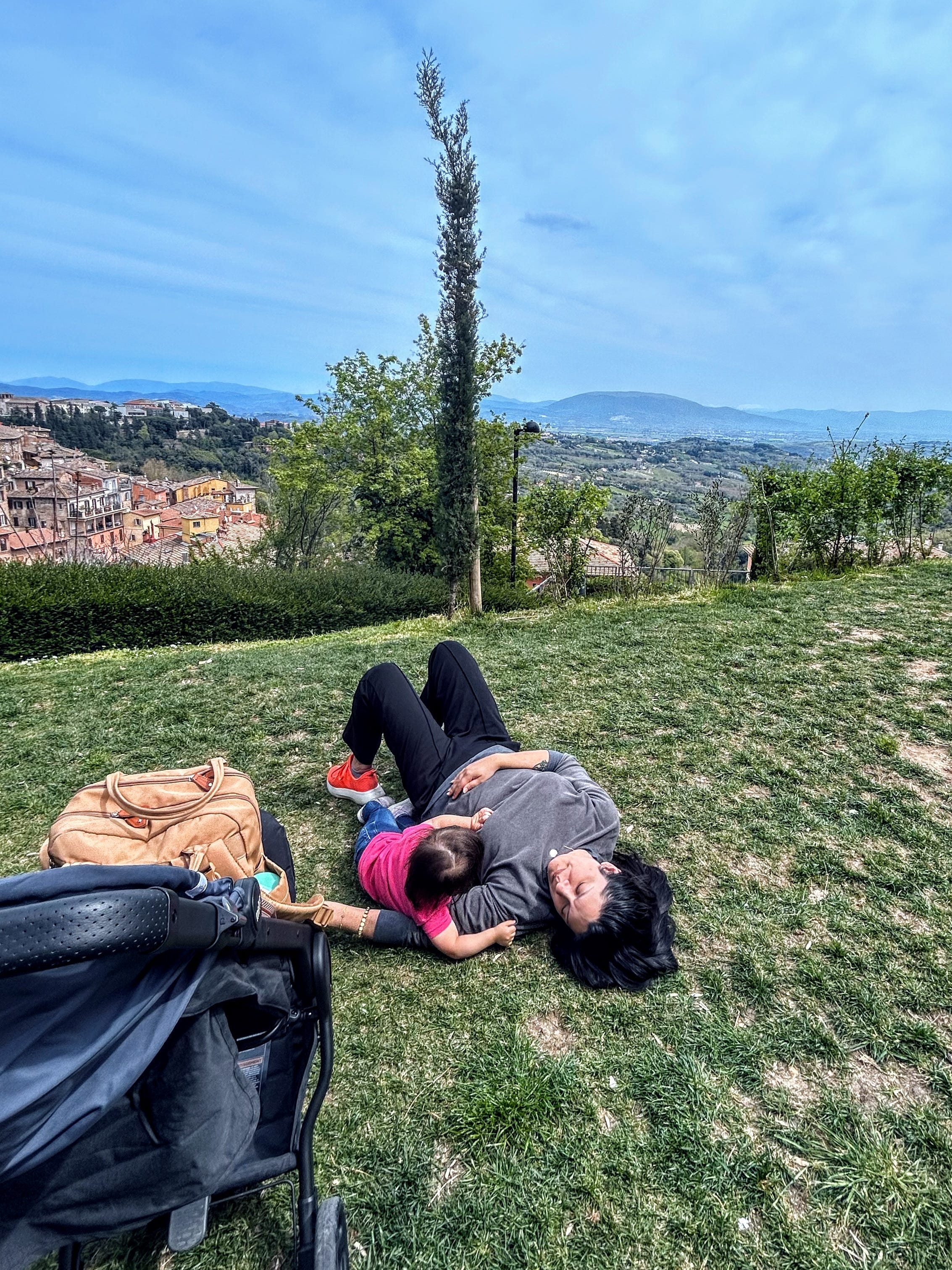 Upasna Gautam with her daughter lying on grass