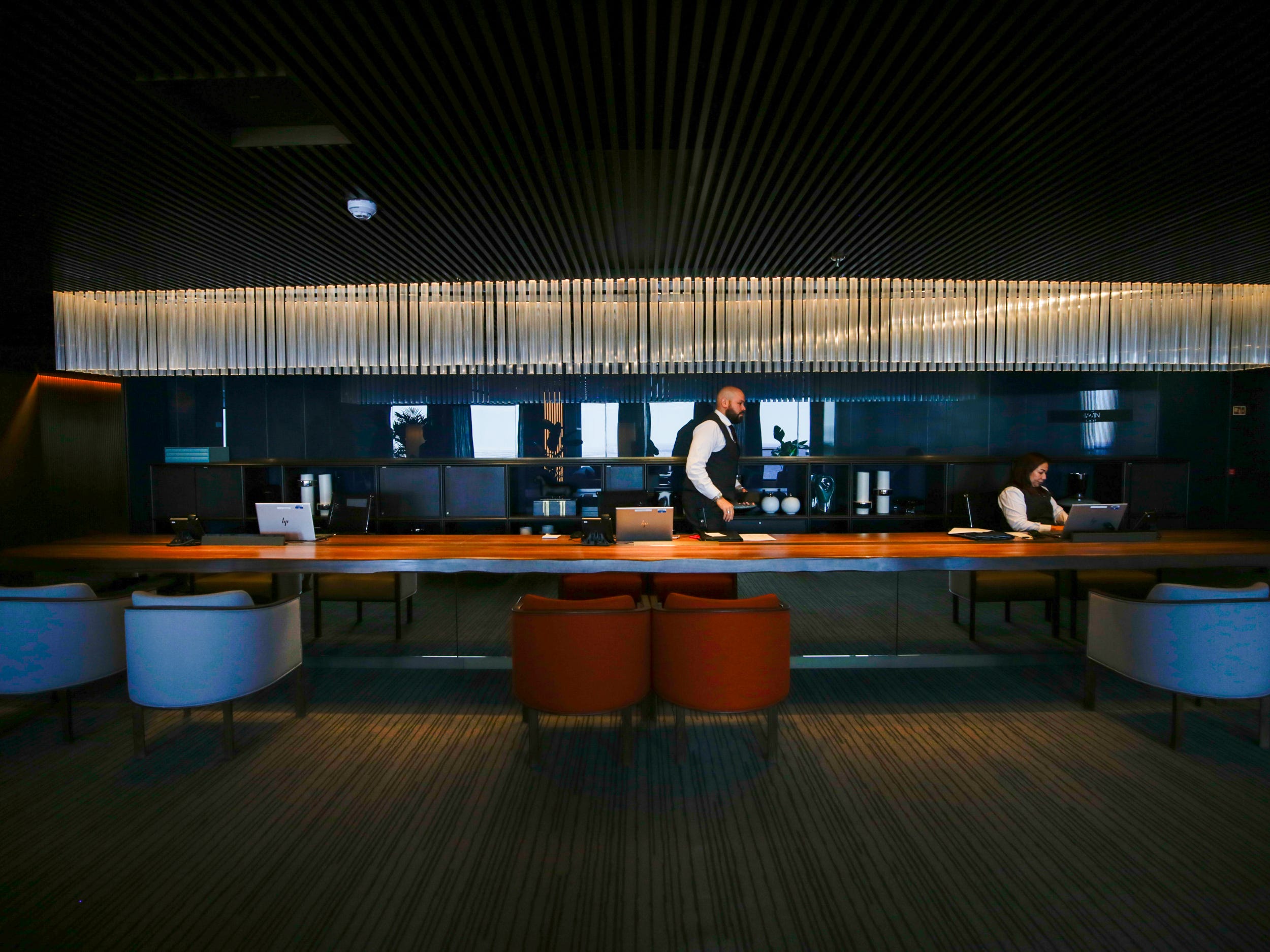 Person behind a concierge desk at the Haven on Norwegian Aqua