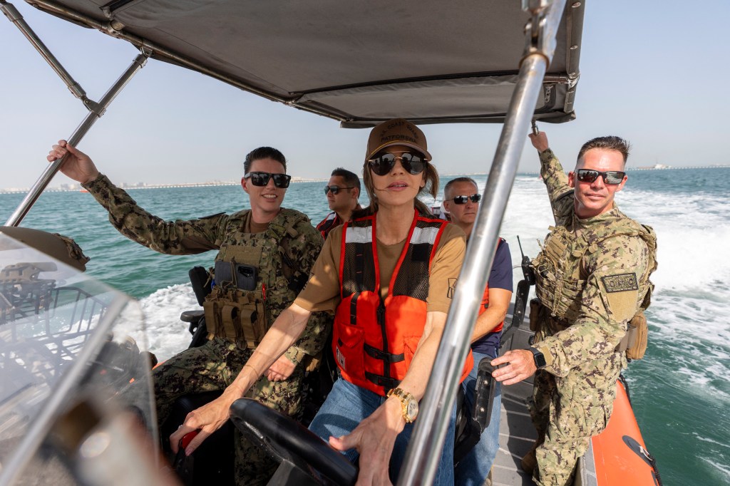 US Homeland Security Secretary Kristi Noem (C) pilots an Over the Horizon Small Boat, Mark 4, at Naval Support Activity in Manama on May 25, 2025.
