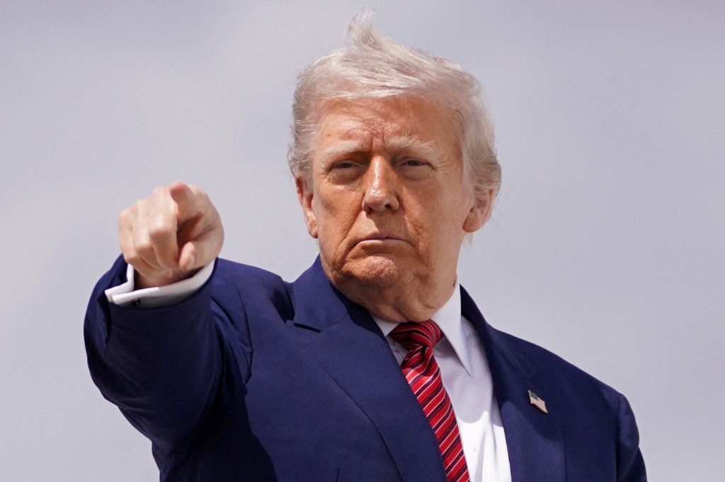 U.S. President Donald Trump gesturing while boarding Air Force One at Joint Base Andrews, Maryland.