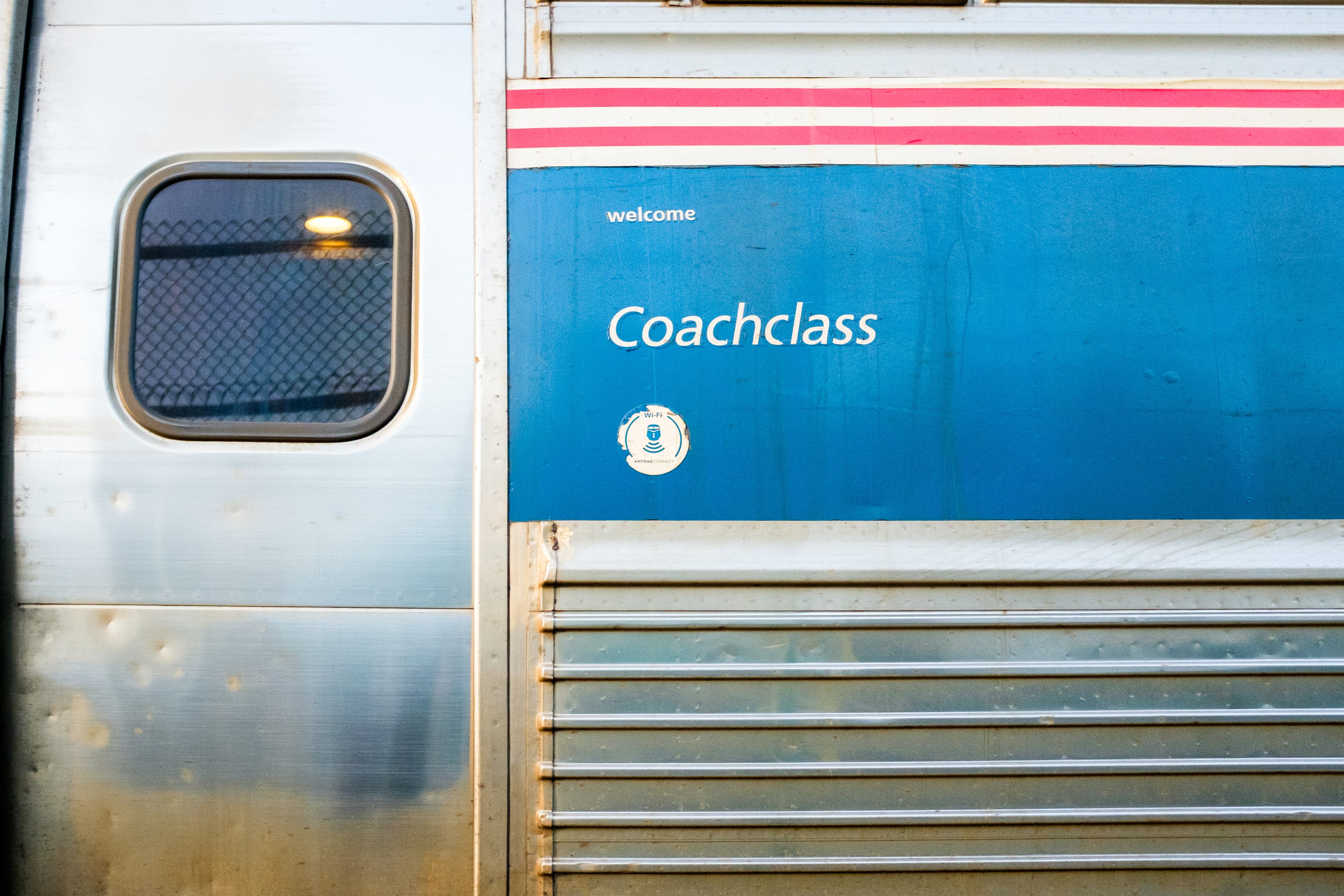 A close-up of a coach car's exterior on an Amtrak train