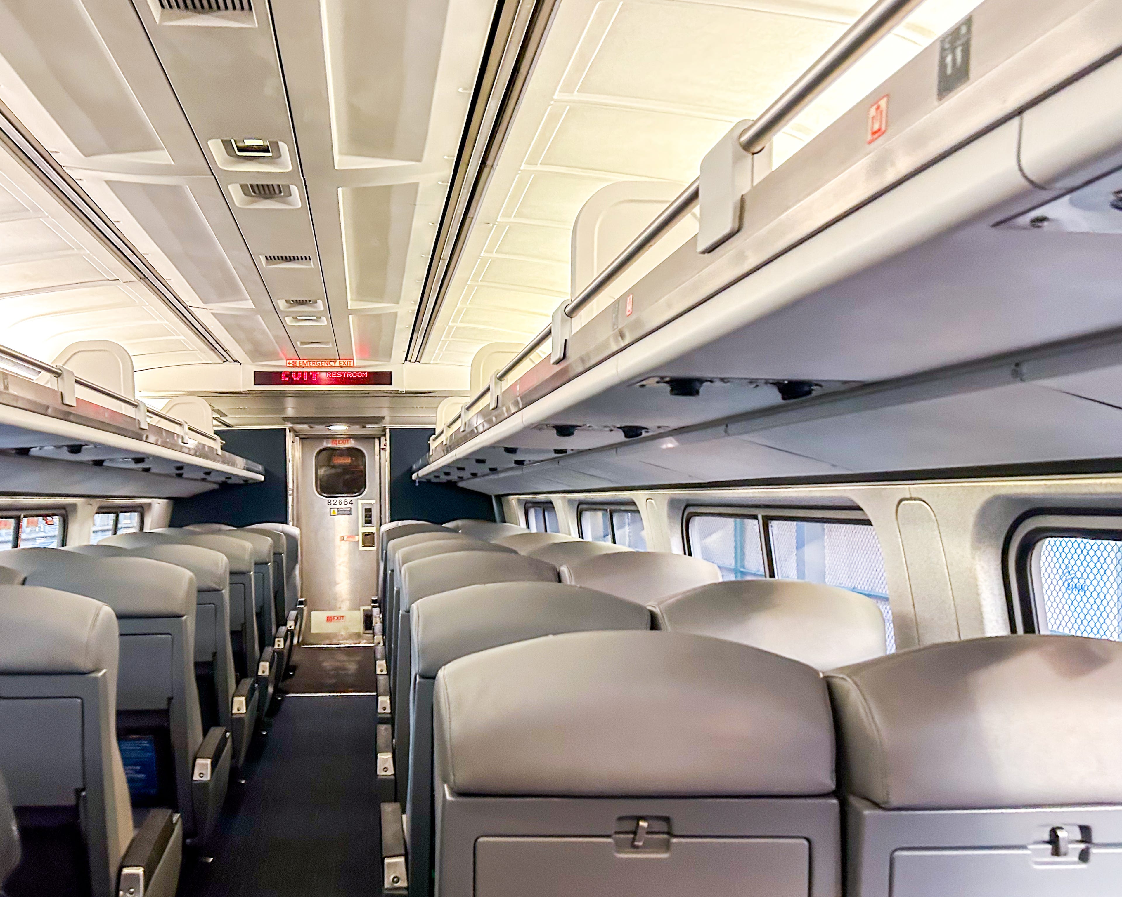 Empty seats and overhead bins on a coach class Amtrak car