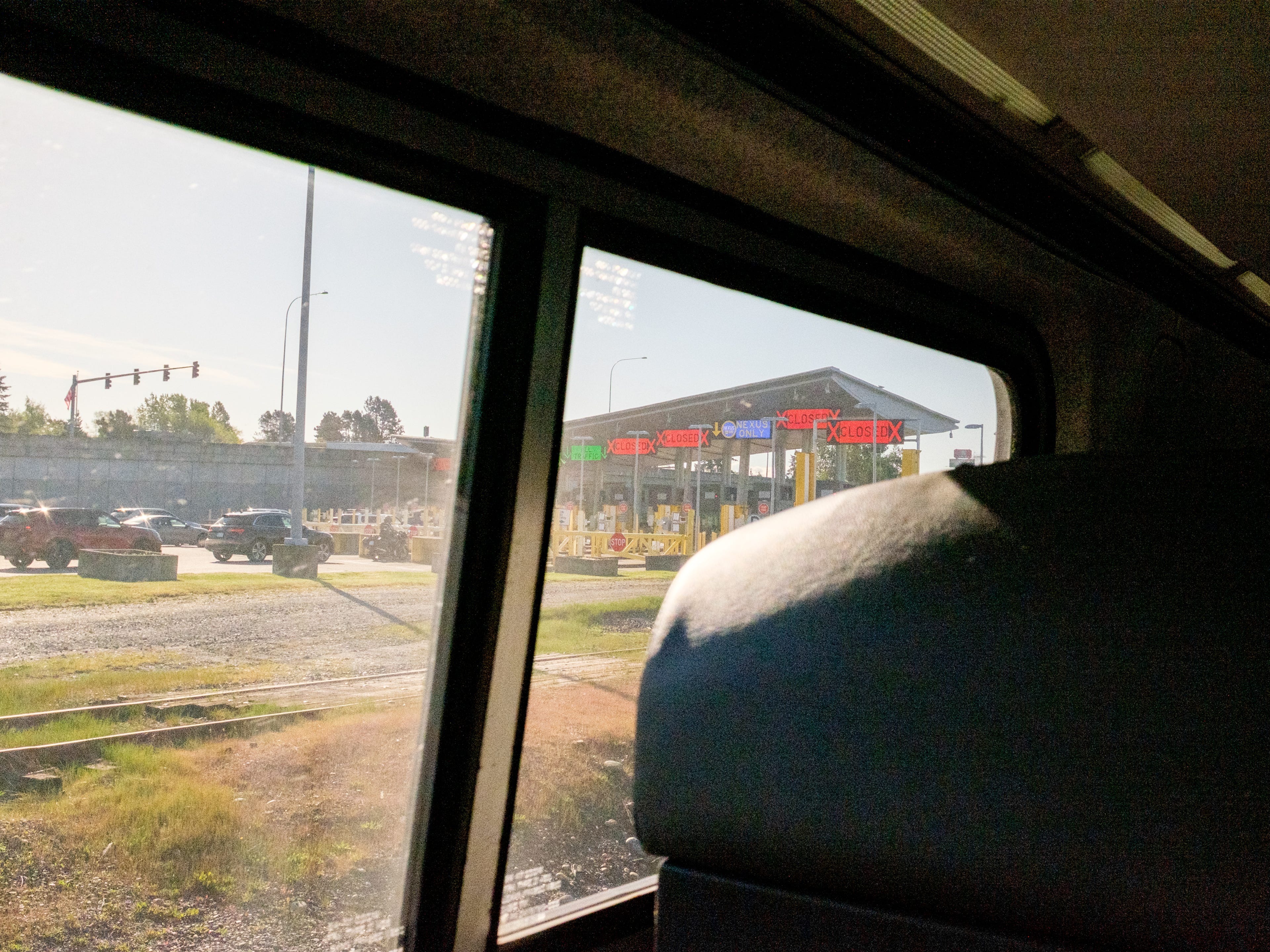 A view of traffic going through a border crossing fron a train window