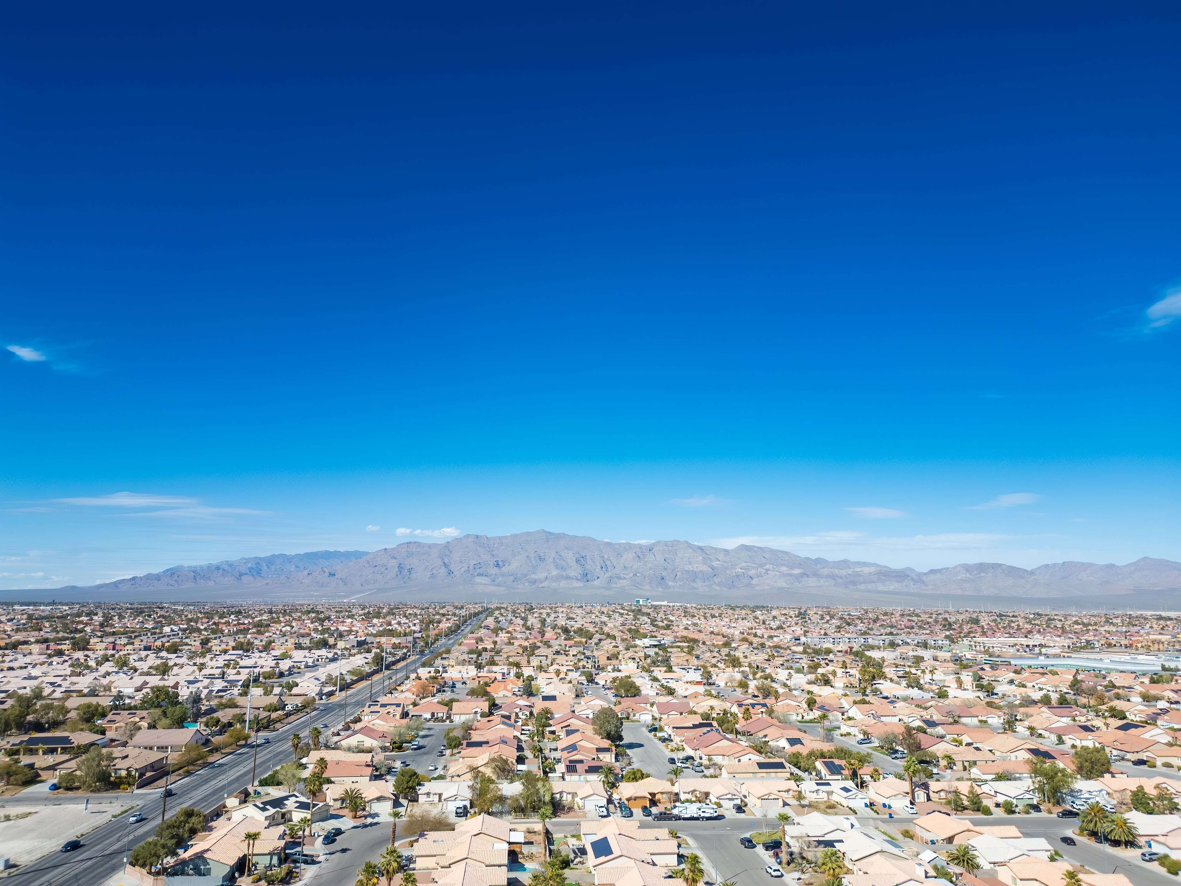Many houses neatly arranged with tan or orange roofs