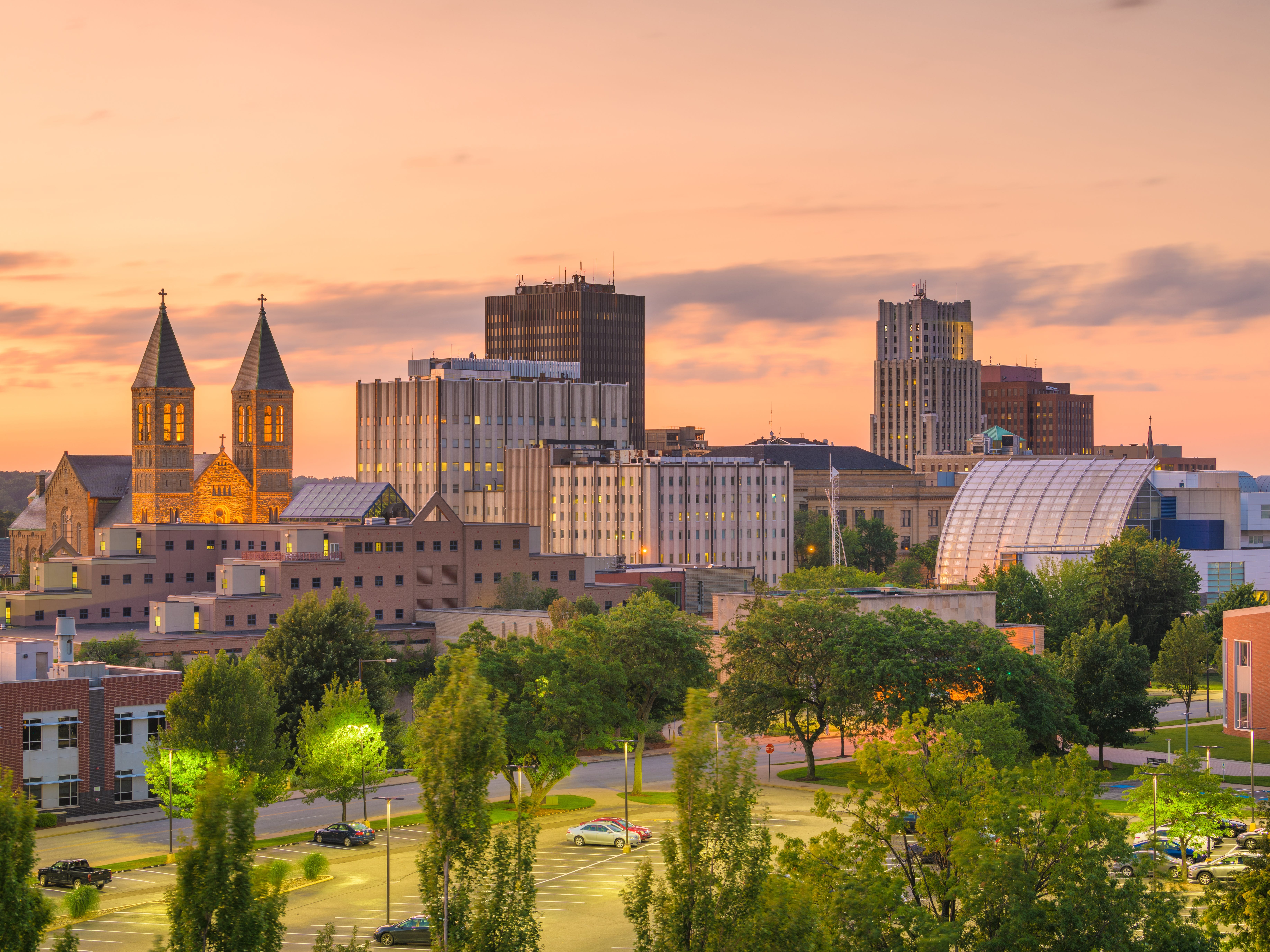 Akron, Ohio skyline at sunset with a church in the background.
