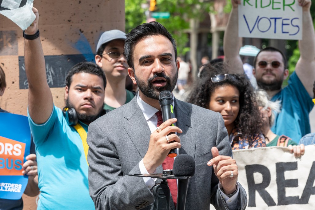 Mayoral candidates Zohran Mamdani and Brad Lander speaking at a Riders Alliance rally in Flatbush, Brooklyn, advocating for improved mass transit infrastructure