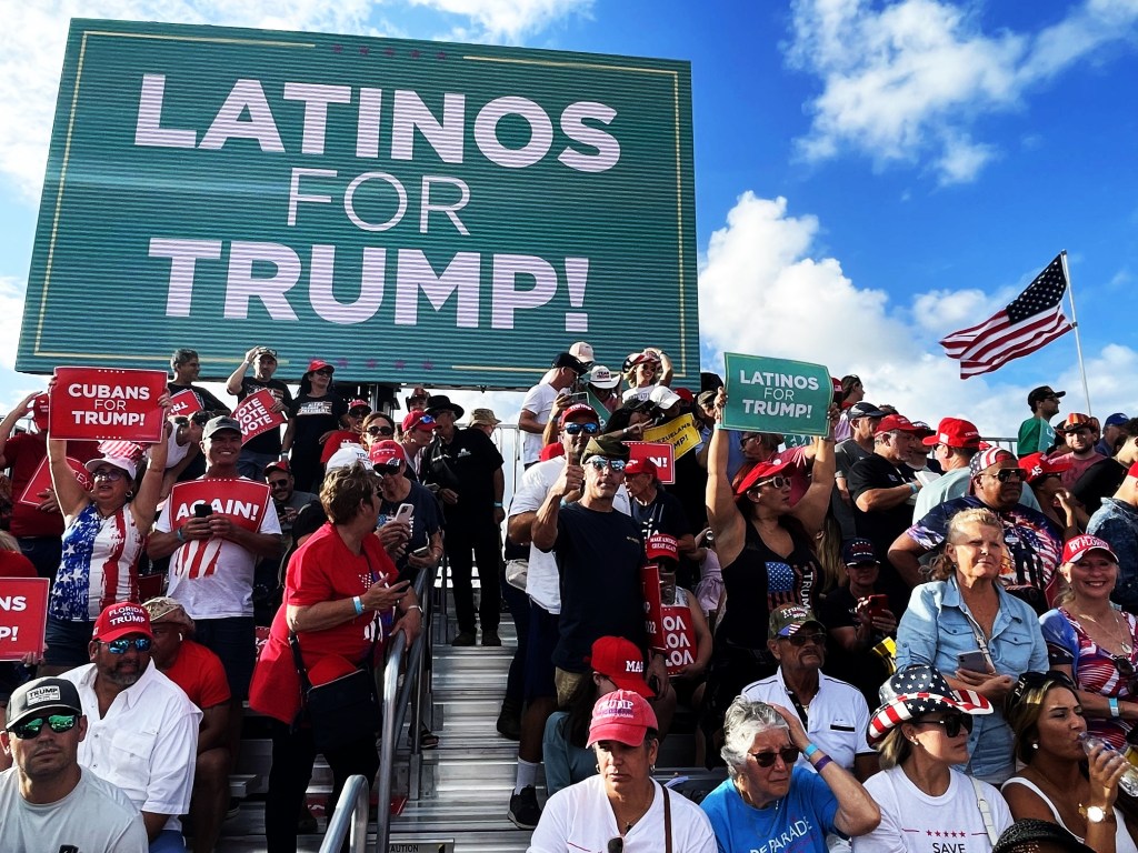 Sen. Ileana Garcia speaking at a Latinos for Trump rally in Miami, Florida with a crowd in the background