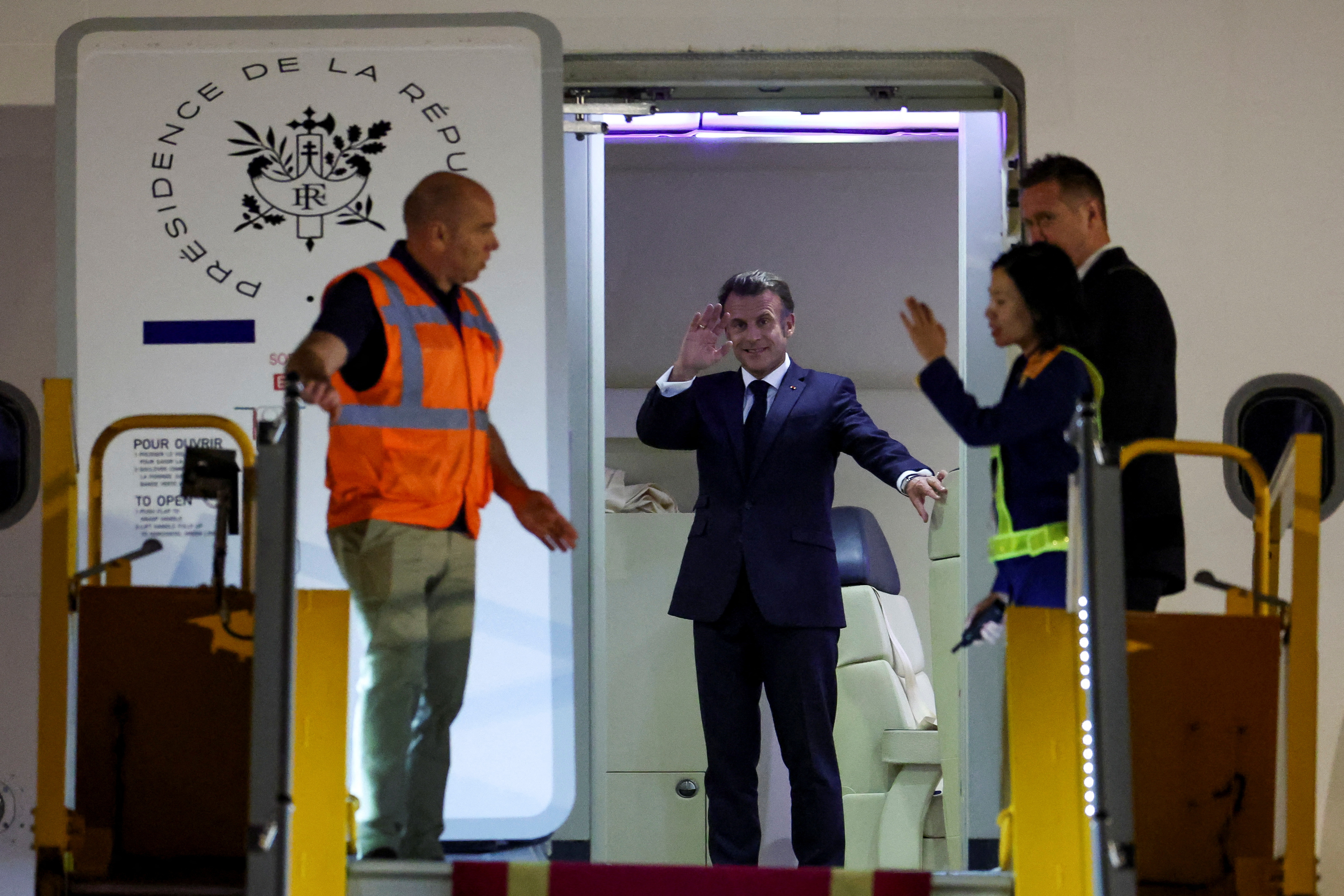 President Macron waving.