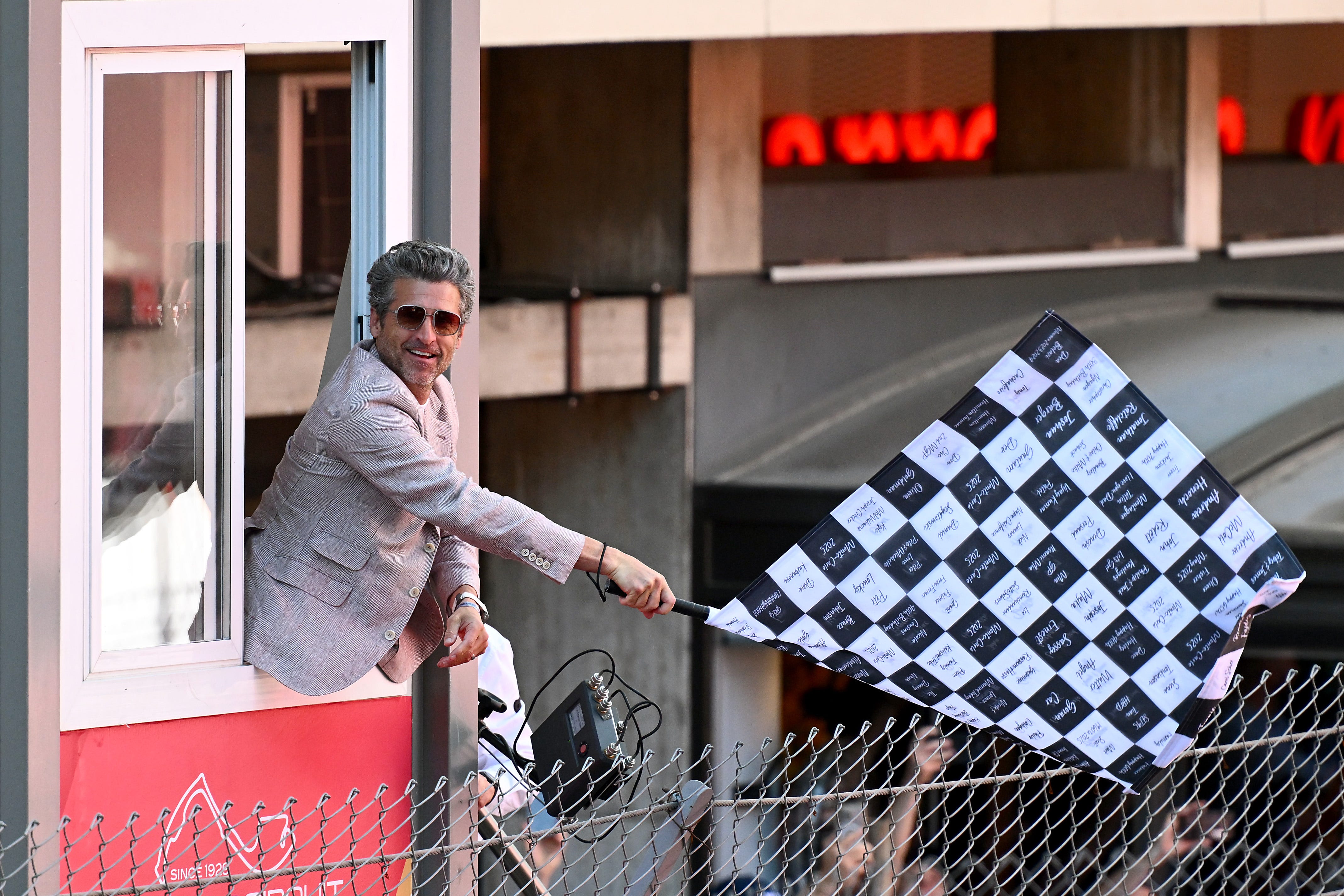 Patrick Dempsey waving the chequered flag during the F1 Grand Prix of Monaco at Circuit de Monaco on May 25, 2025, in Monte-Carlo, Monaco.