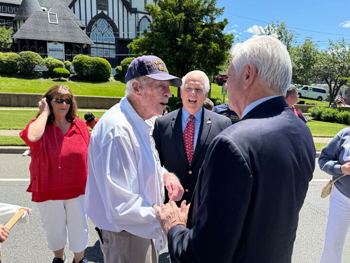 Blakeman shaking hands with 95-year-old Ben Farnan — the oldest veteran in the parade.