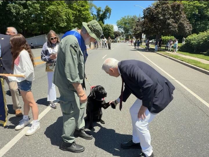 Blakeman greeting local Vietnam vet Howard Stillwagon and his service dog Cruiser.
