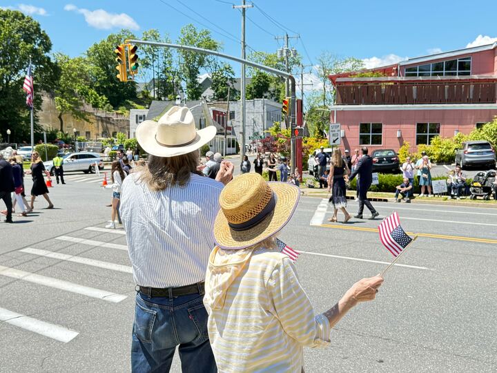 Nassau County residents waiving flags during the Glen Cove parade.