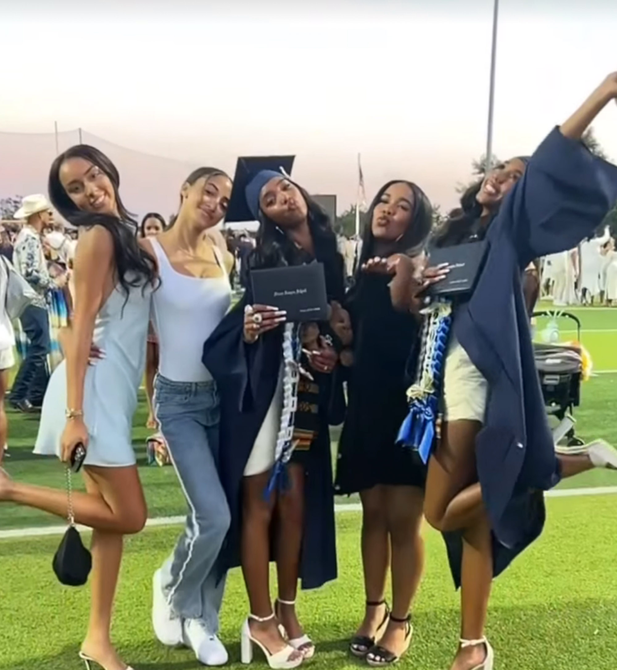 Jessie and D'Lila Combs with friends on their graduation day.