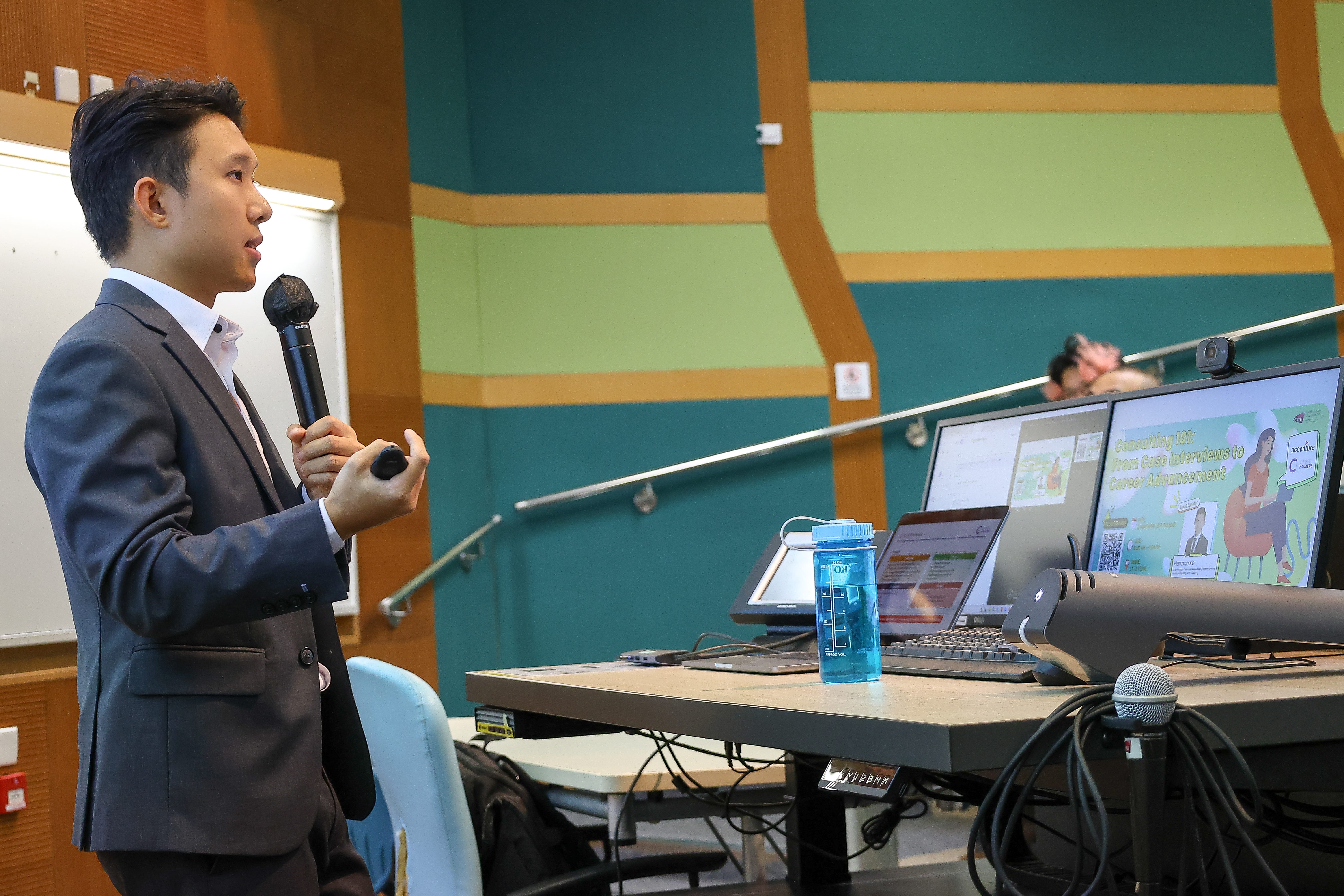 Herman Ko presenting to students in a lecture theatre.