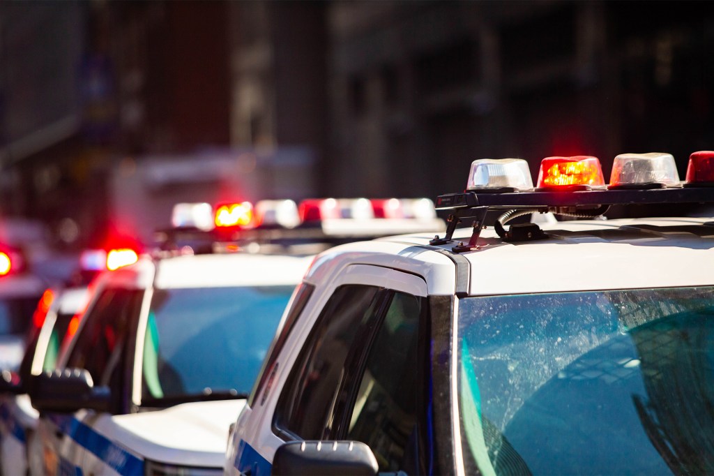 The squad car, carrying three officers and a 32-year-old passenger, attempted to dodge the taxi when it hit a 63-year-old man and a 74-year-old woman seated at an outdoor dining area.