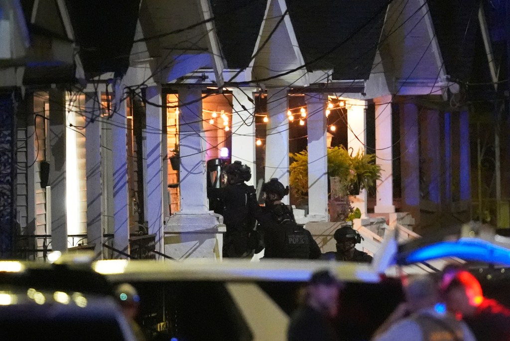 Louisiana state police enter a house on North Galvez street as they pursue a fugitive that escaped from a New Orleans jail, Tuesday, May 20, 2025, in New Orleans. 