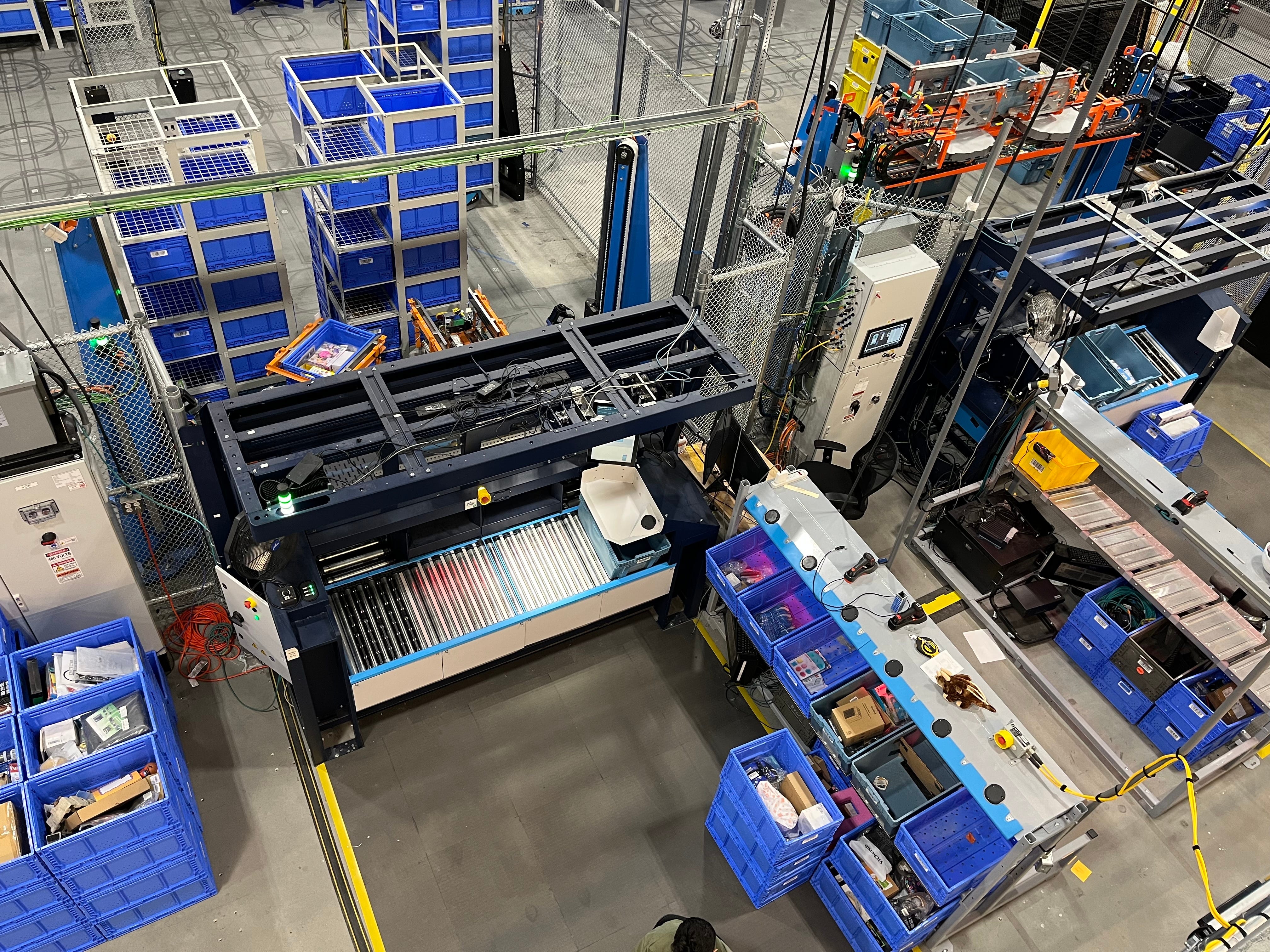Looking down on a Sequoia robotic system with blue totes inside Amazon Robotics facility in Westborough, Masachusetts