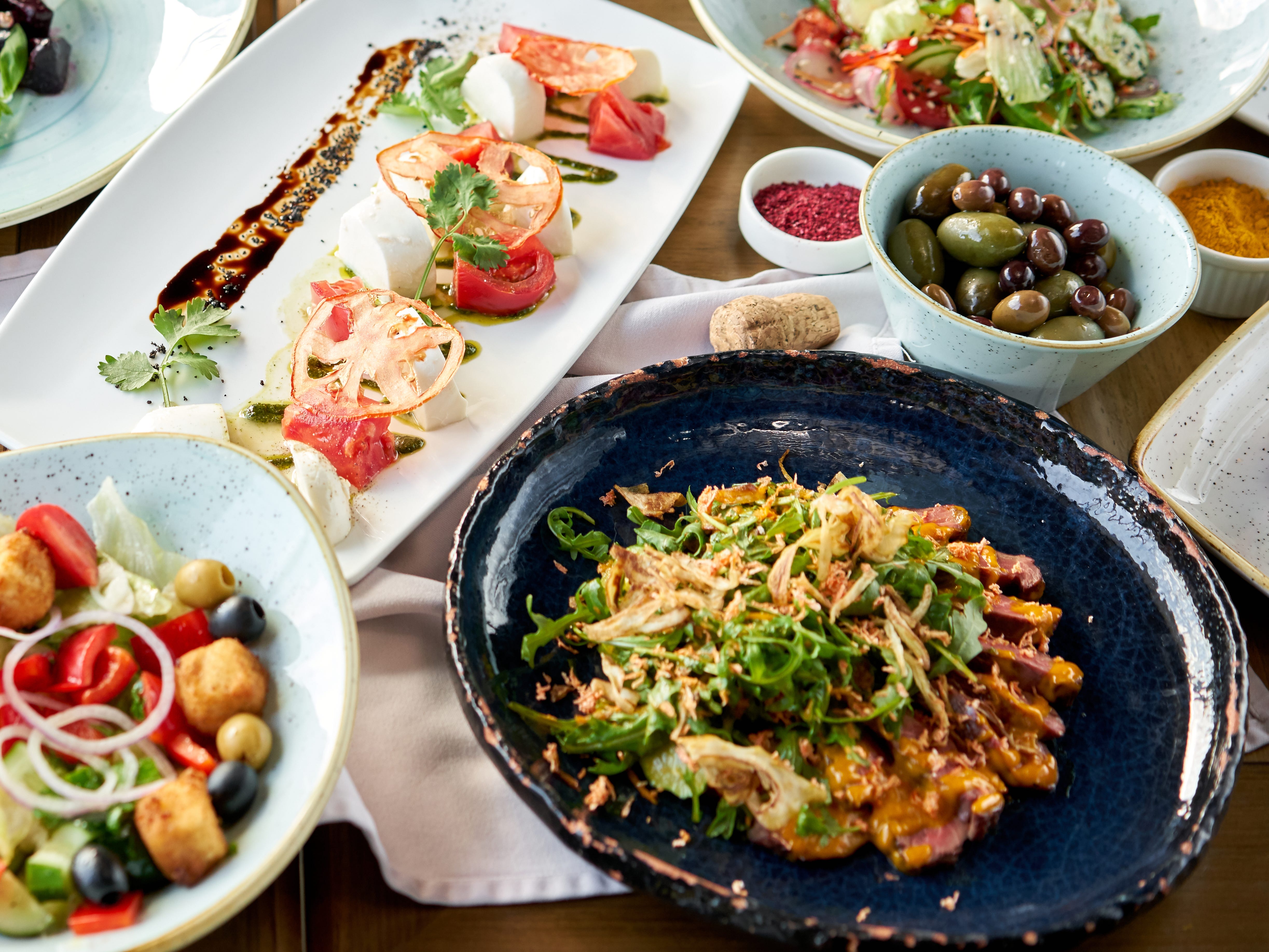 A variety of plates with food on a table.