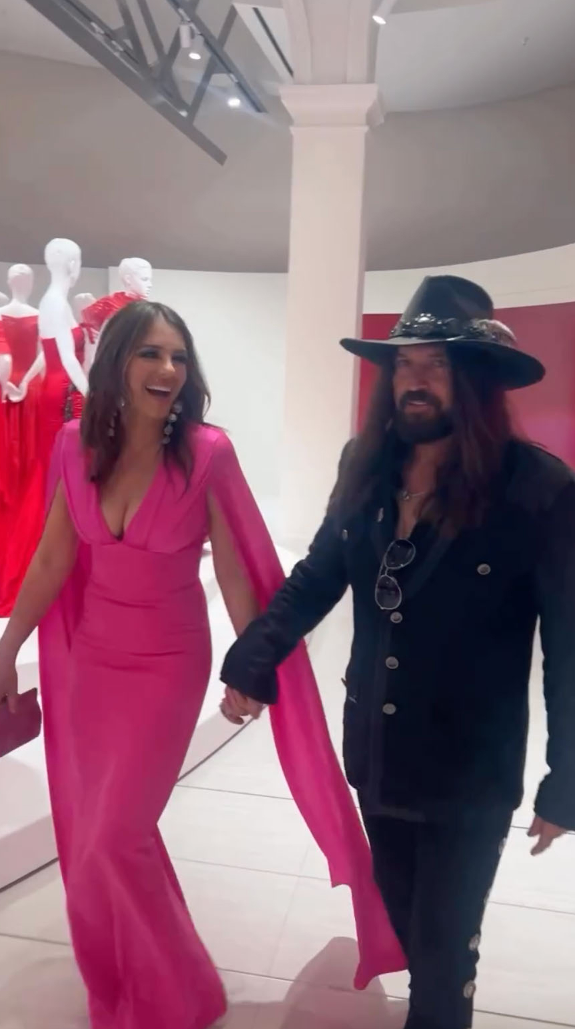 Billy Ray Cyrus and Elizabeth Hurley holding hands in Rome