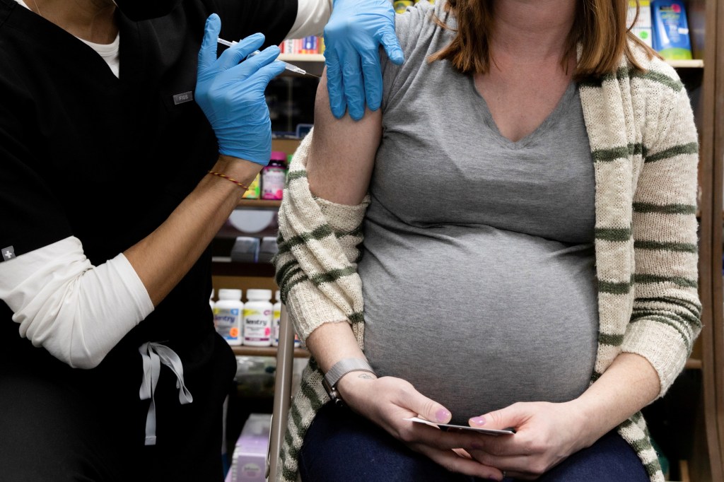 A pregnant woman receives a vaccine for the coronavirus disease.