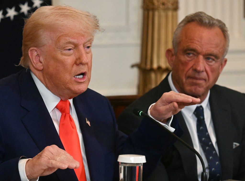 President Donald Trump speaks as US Secretary of Health and Human Services Robert F. Kennedy Jr. looks on during a MAHA (Make America Healthy Again) Commission Event in the White House in Washington, DC, on May 22, 2025. 