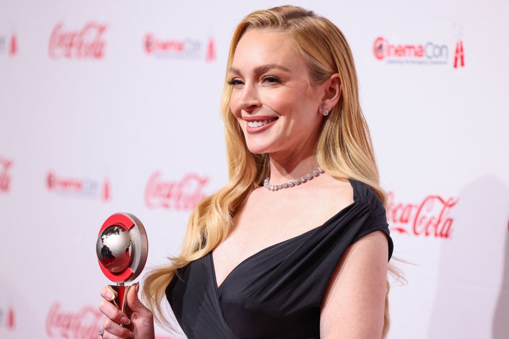 Lindsay Lohan smiling on the red carpet for the CinemaCon Big Screen Achievement Awards 2025 