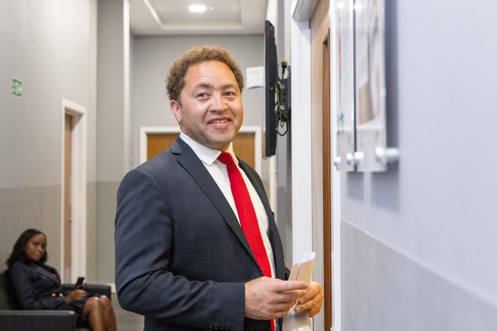 RAF veteran Calvin Bailey, a Labour party member of parliament, smiles in a suit on the night of the UK's 2024 general election.