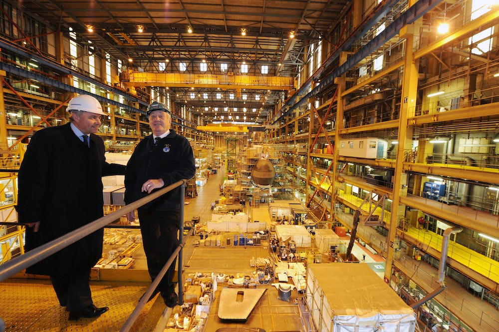 Terry Spurling (right) a former engineer officer of the watch who served on HMS Dreadnought for more than seven years and Tony Burbridge who works on the Astute class subs, stand near the construction of the Ambush submarine at the BAE Systems in Barrow-in Furness.