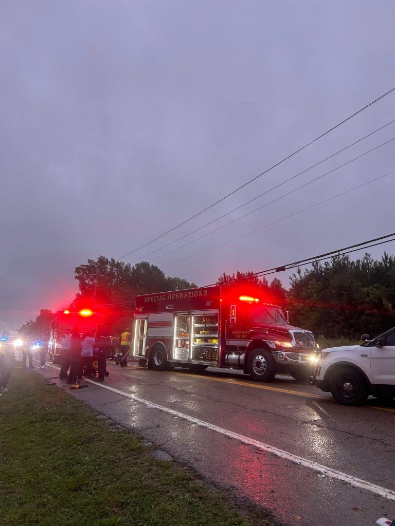 Greyhound bus and passenger vehicle crash scene on a Tennessee highway, causing fatalities and numerous injuries