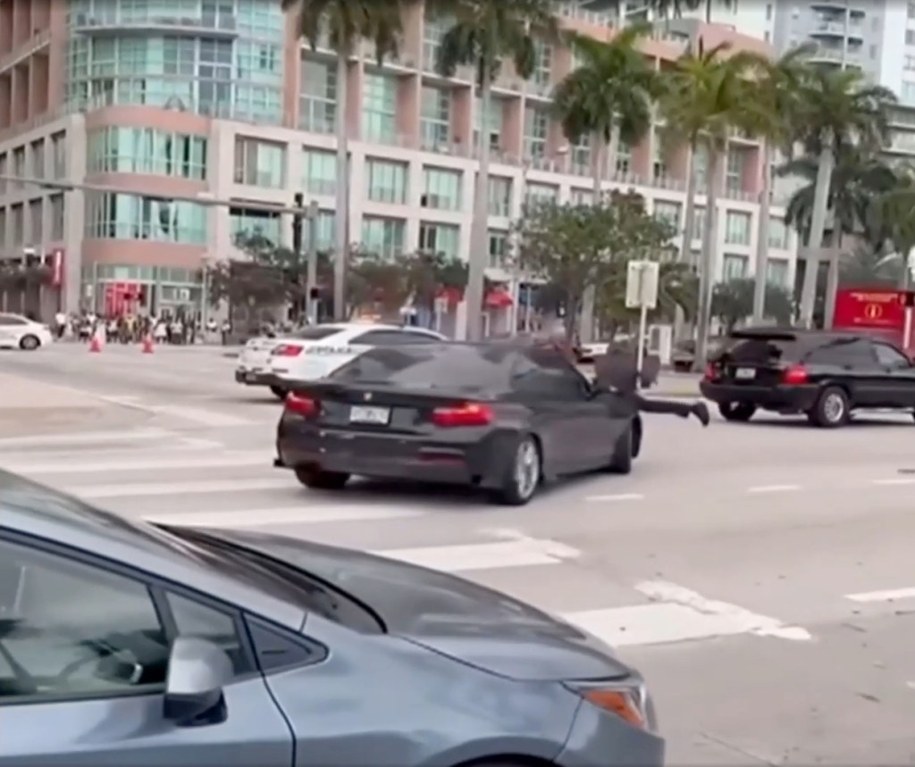 the vehicle tries to turn left but rolls to a stop -- allowing the cop to jump off to safety and the driver’s side door to swing open.