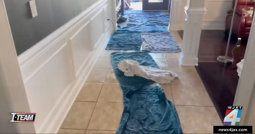 Towels are placed all over the flooded floor of the Byrd's Jacksonville home after their failed fridge installation on Dec. 2, 2024.