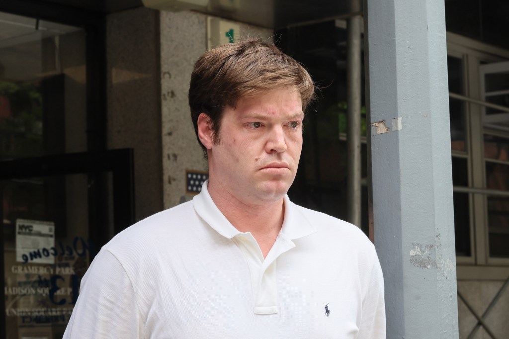 William Duplessie walking out of the NYPD 13th pct in cuffs.