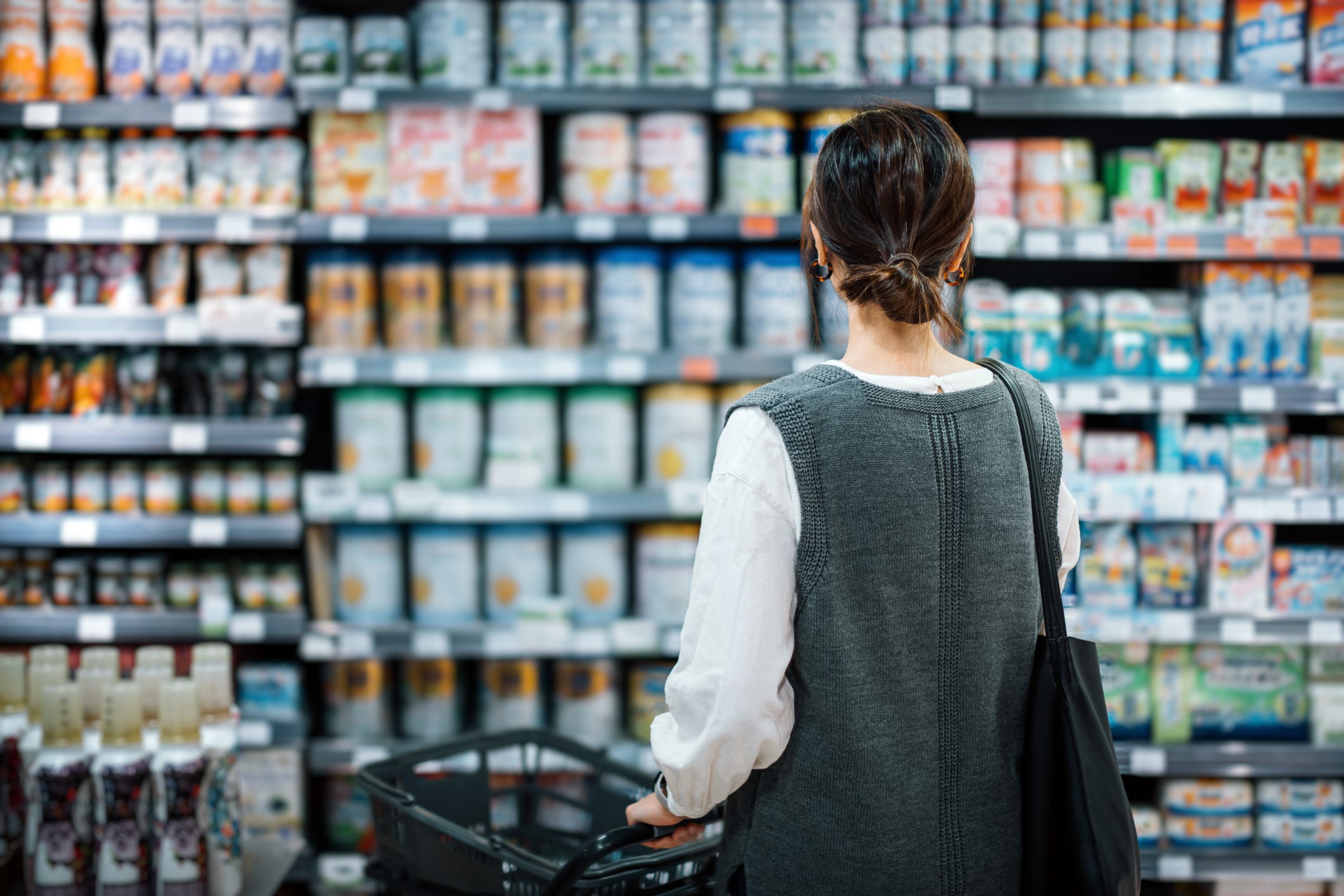 A woman stands in a grocery aisle