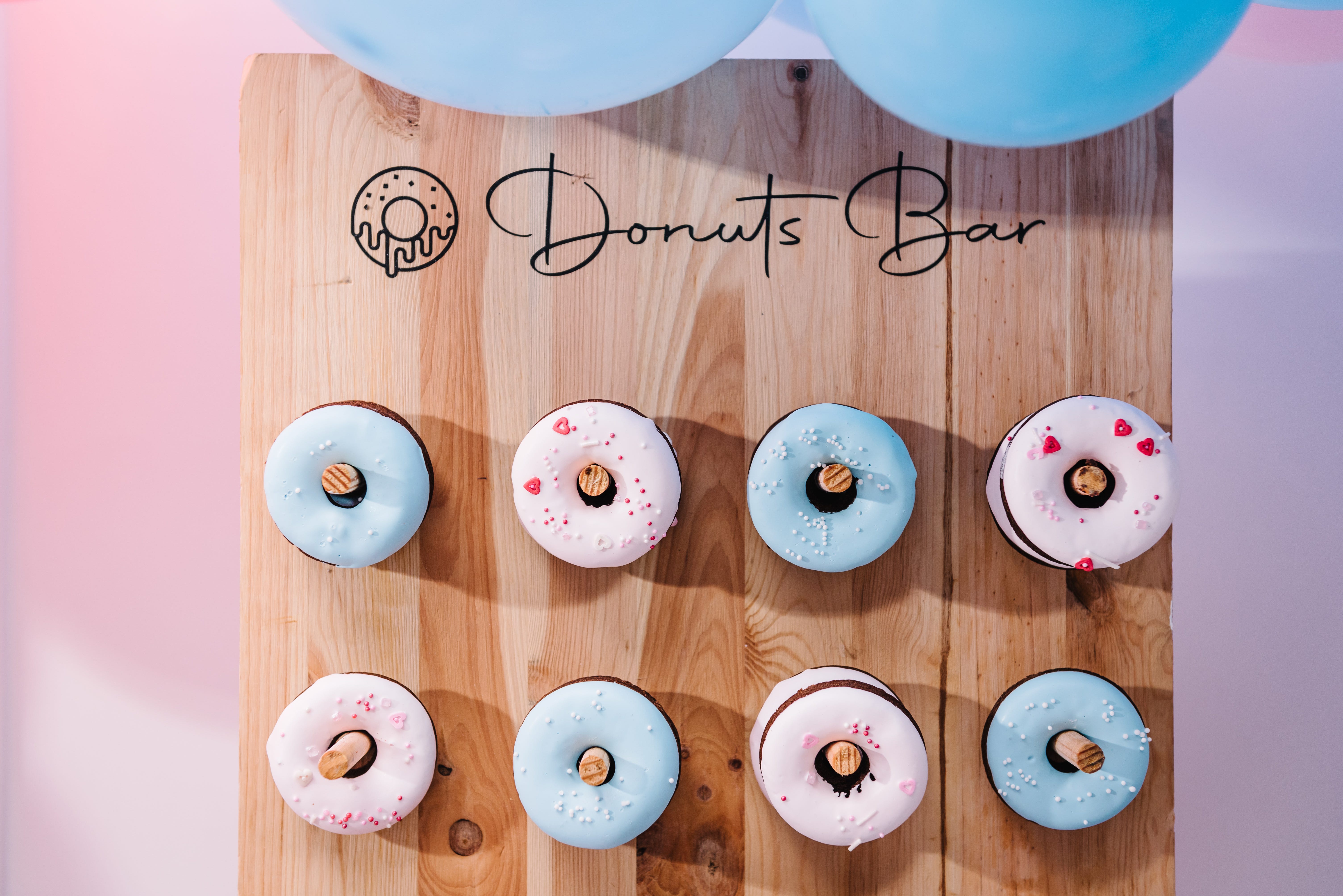 Donuts bar with donuts on wooden pegs on wall