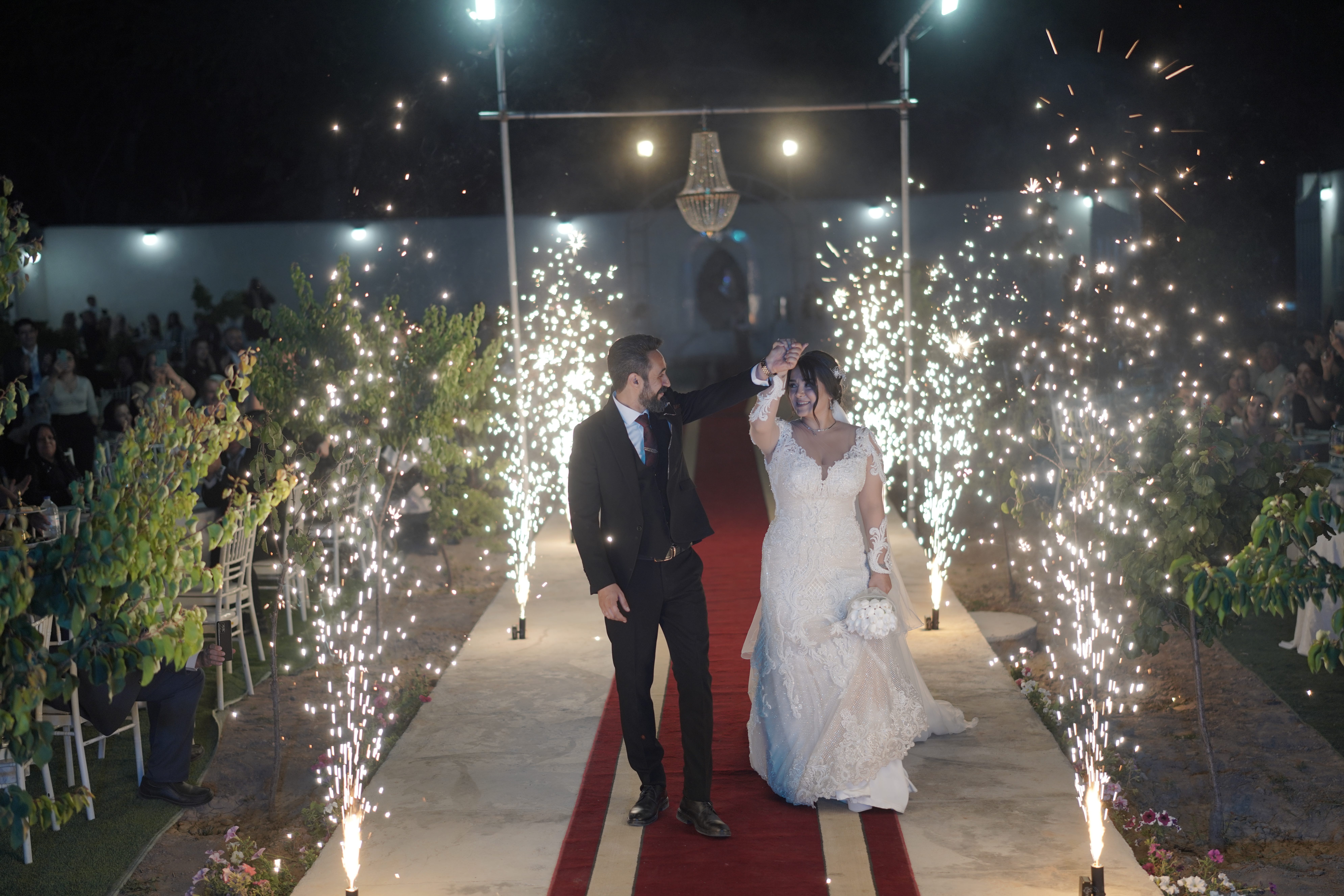 Sparklers going off next to bride and groom