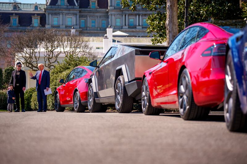 President Donald Trump, accompanied by Elon Musk and his son X Æ A-Xii, speaks next to a lineup of Tesla cars on display at the White House on March 11, 2025 in Washington, D.C.