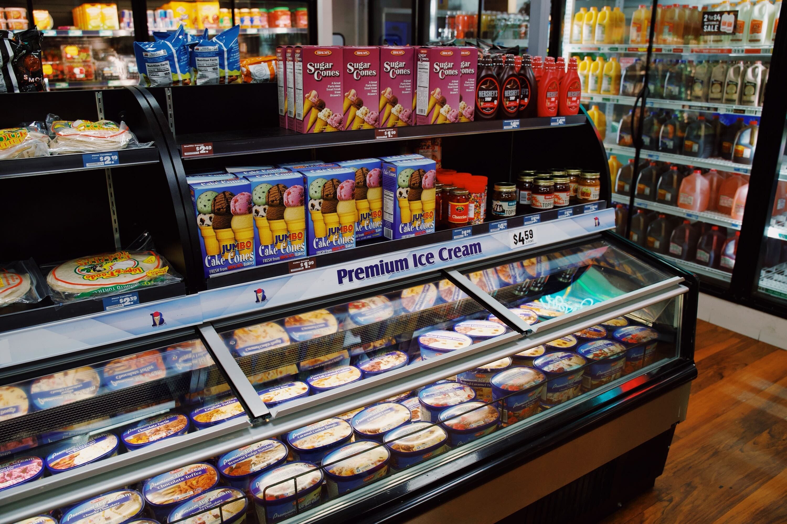 An overview of Braum's ice cream selection and it's sugar cones, and syrup.