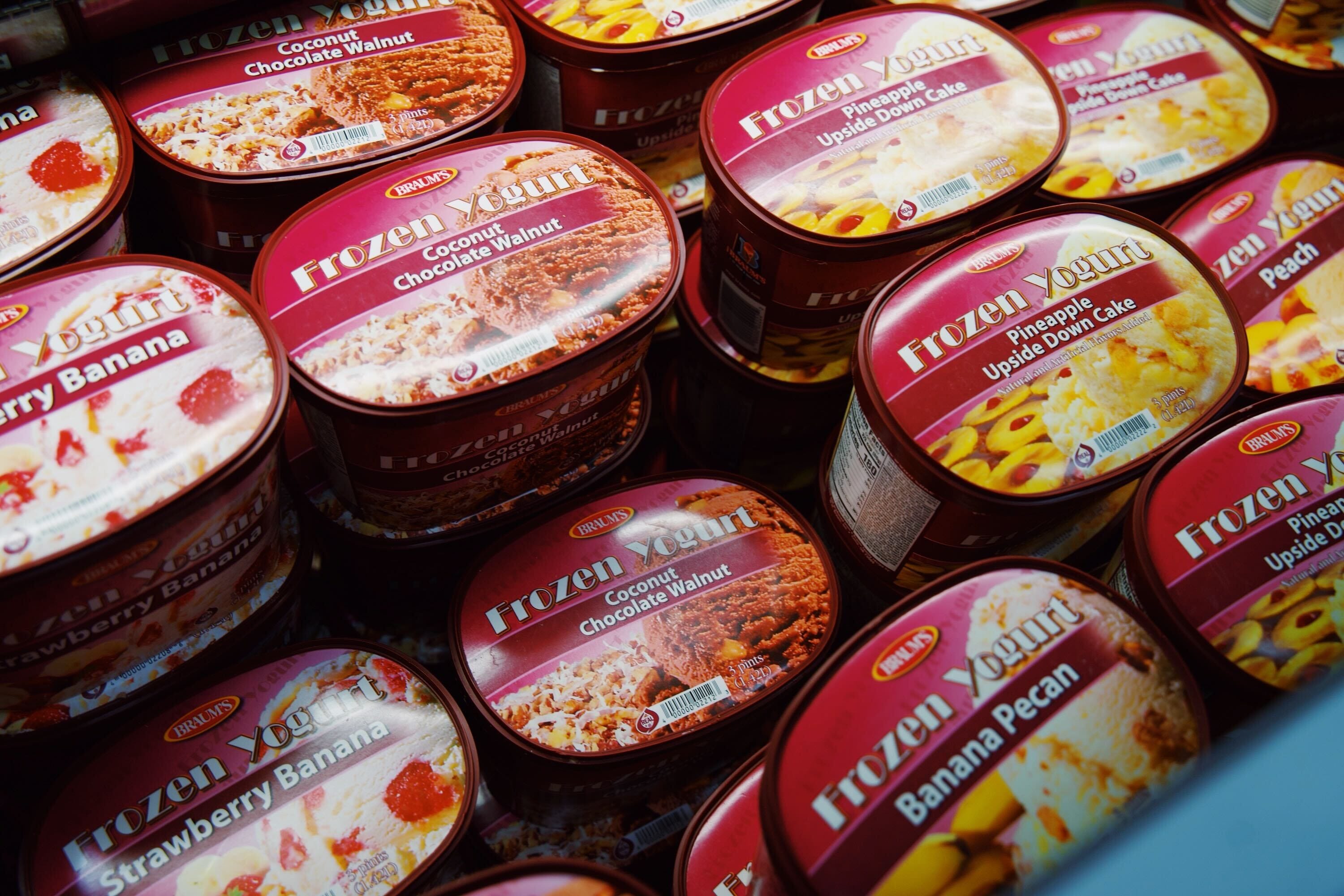 Buckets of Braum's frozen yogurt, including flavors like pineapple upside down cake, coconut chocolate walnut, and banana pecan.