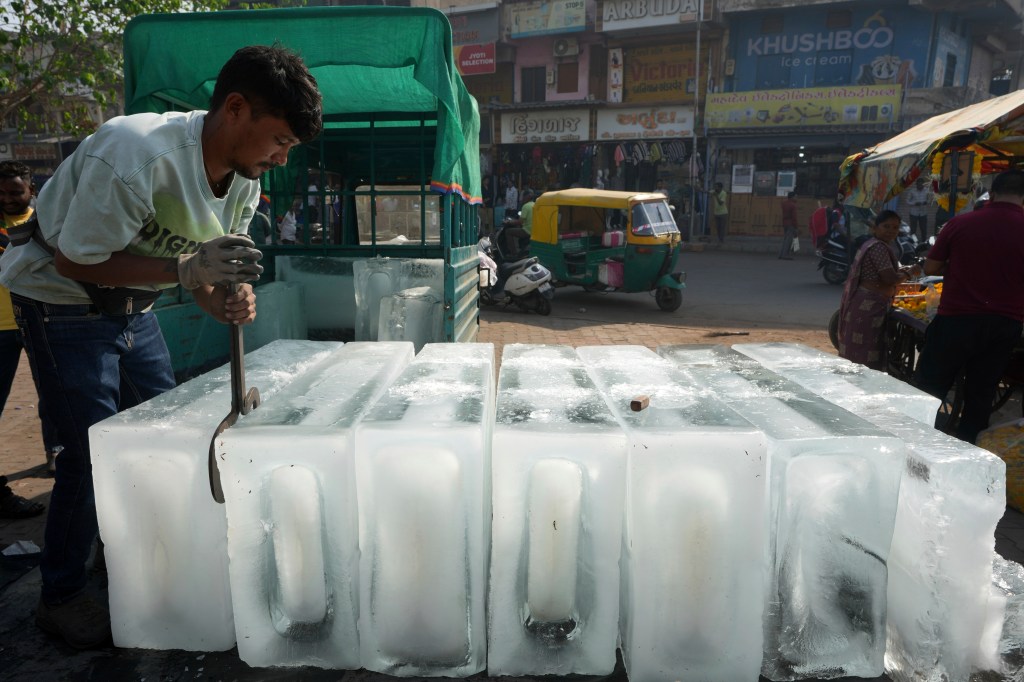 A man arranges ice blocks to sell at his stall in Ahmedabad, India, April 2, 2025. 