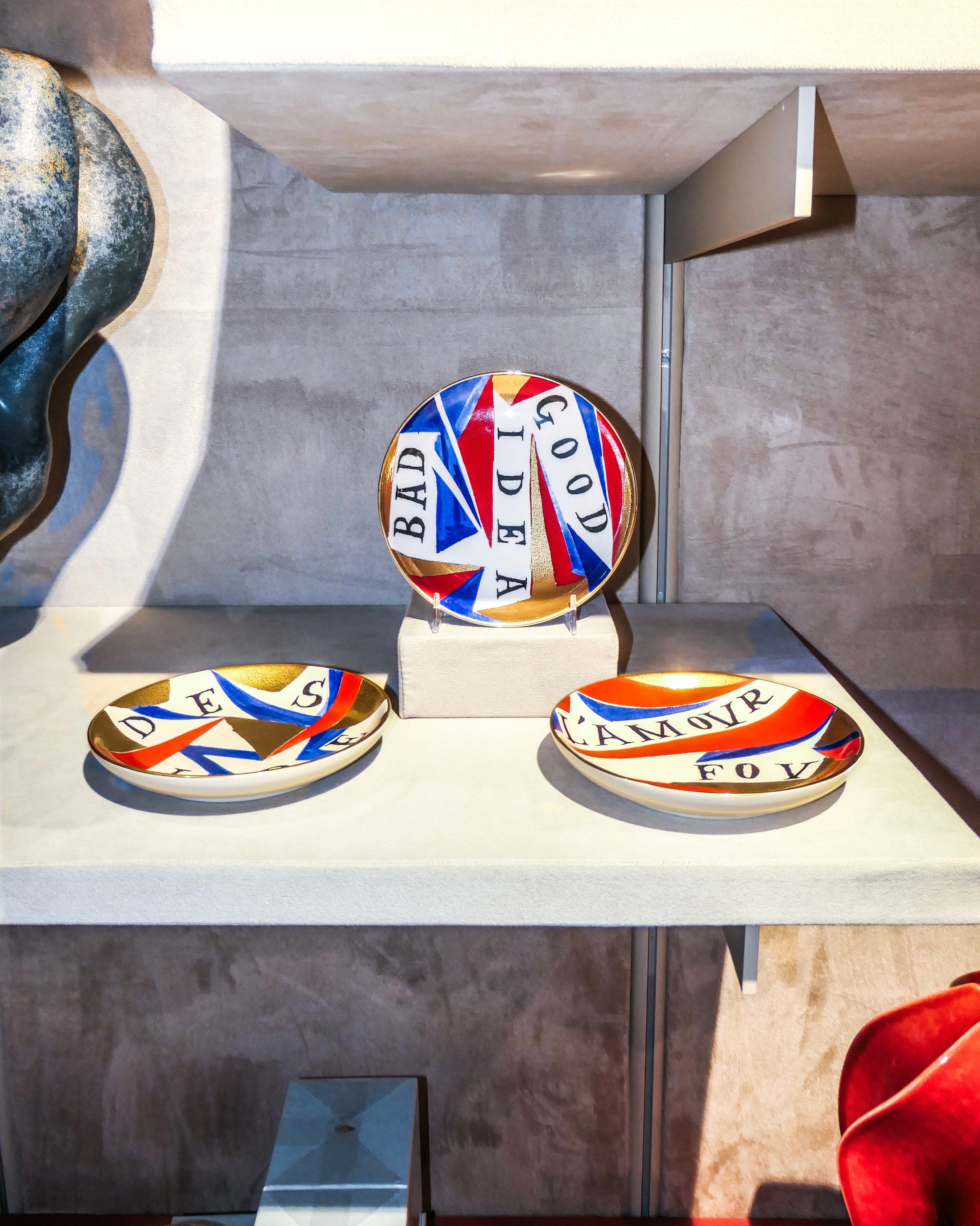 Handcrafted L'Objet plates painted red, white, blue, and gold from the Ruan Hoffmann collection